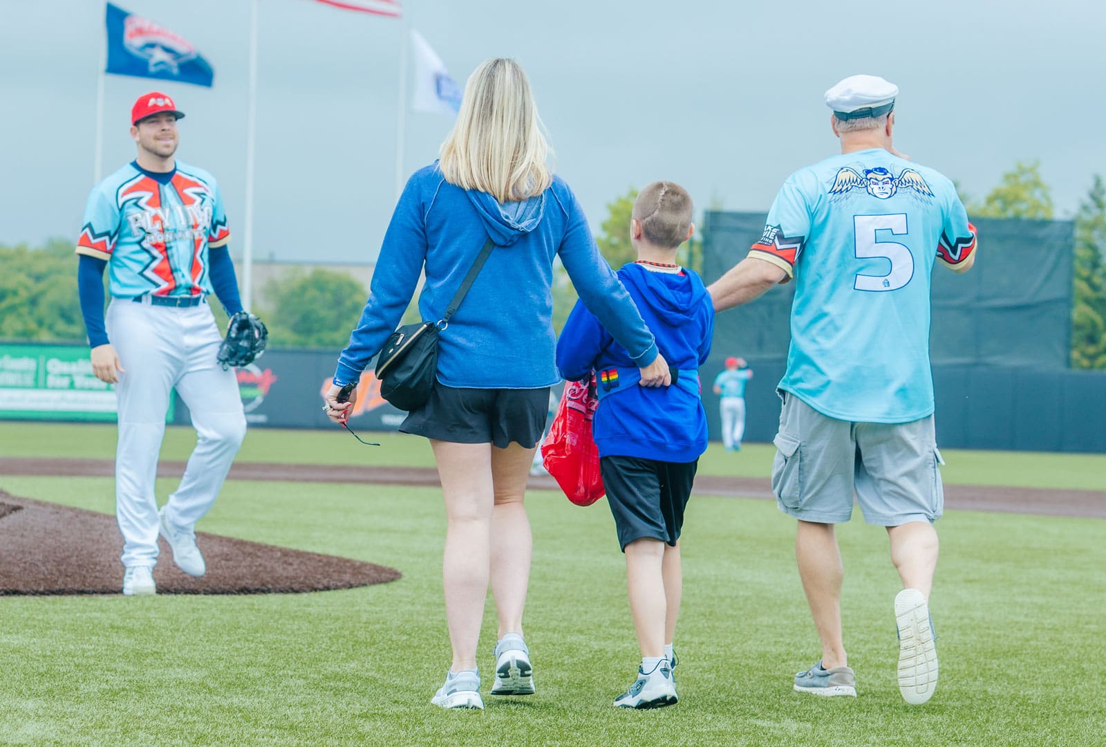 Wesley delivers the game ball to DockHounds pitcher, Brett Conine