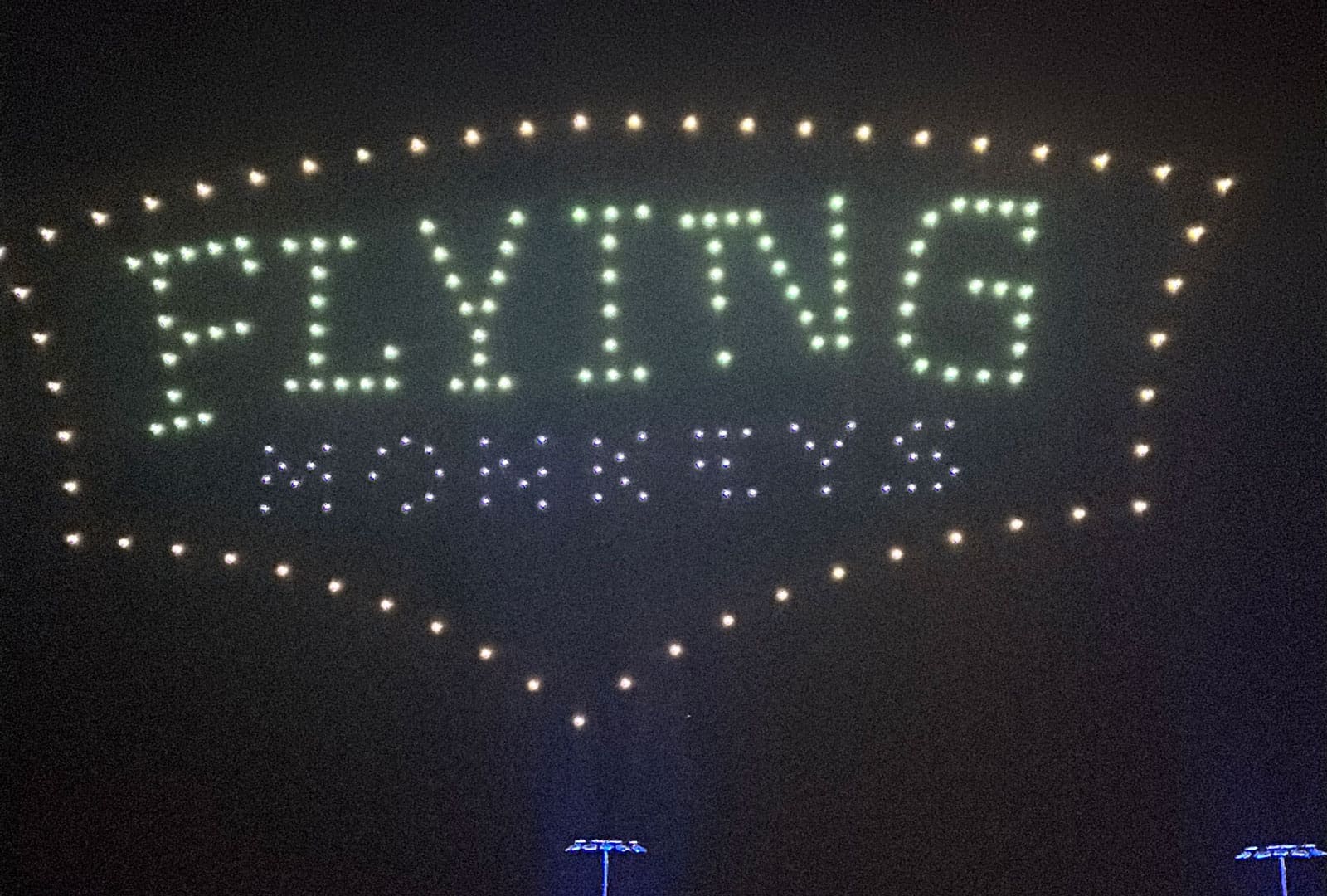Flying Monkeys logo spelled out in drones in the sky